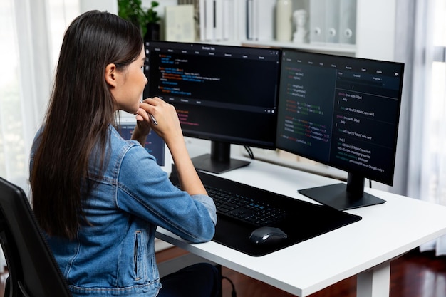 Young asian in it developer looking online information on pc to pose stratagem