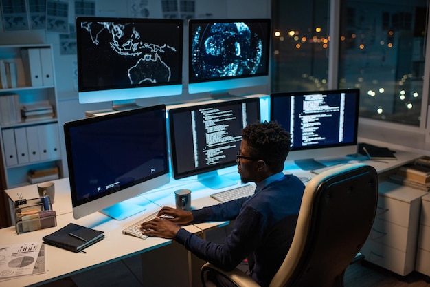 Young contemporary software developer working by computer