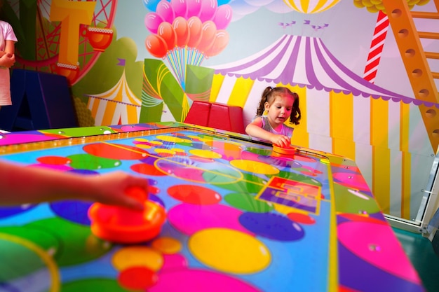 Young girl engaging in colorful board game fun at a vibrant playroom
