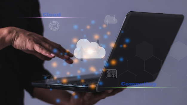 Young Man holding laptop computer notebook and cloud computing diagram in hand Data storage Cloud