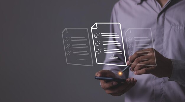 Young man holding smartphone mobile hand using a pen touching to sign a online business contract