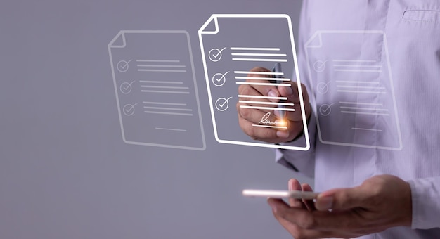 Young man with smartphone mobile hand hold a pen touching to sign a online business contract