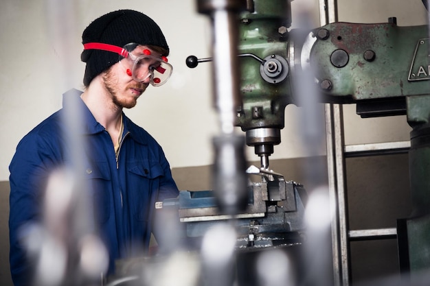 Young man working in factory