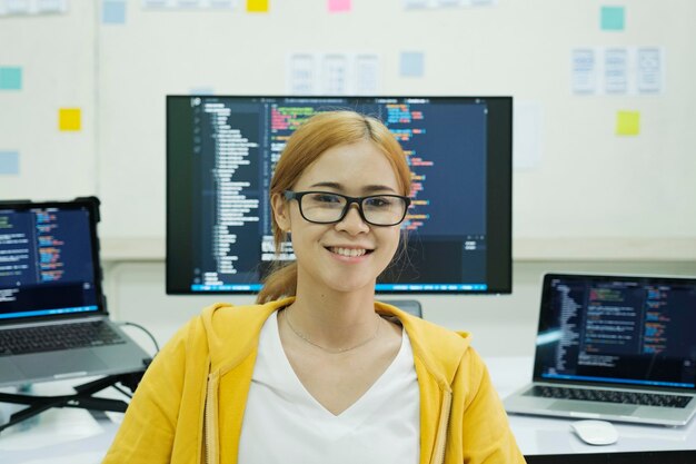 Young programmer or IT specialist satisfied with her work done