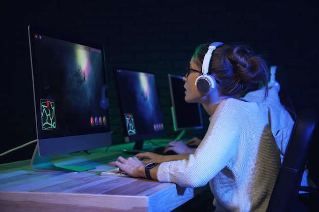Young women playing computer game in club