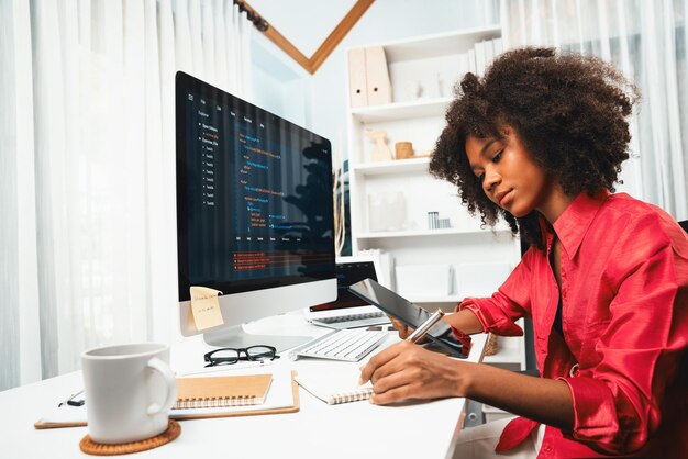 Young working African woman creating coding website developer Tastemaker