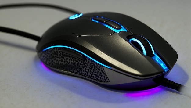A black gaming mouse with blue lights on the bottom