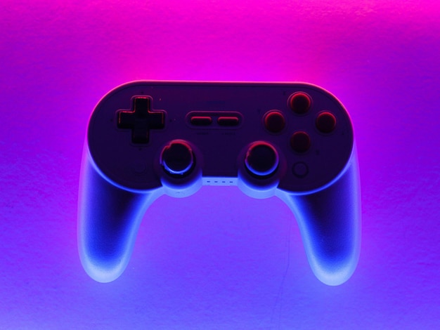 a controller with a blue light that says joy on it