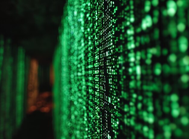 a dark room filled with glowing green pixels the pixels are all different shapes and sizes and they are all moving in different directions