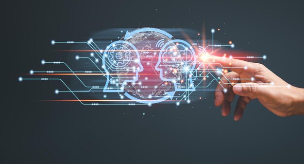 a hand is pointing at a computer screen with two faces on it