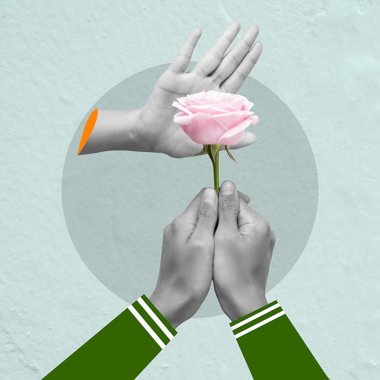 Fotoğraf a human hand holding a pink rose flower
