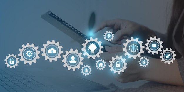 A person using a laptop with icons like icons like the world globe and light bulb