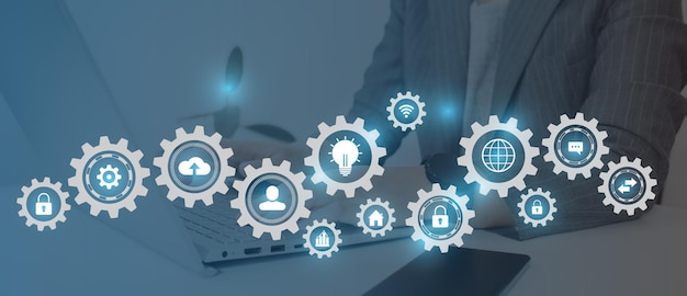 A woman is working with gears and icons of business people