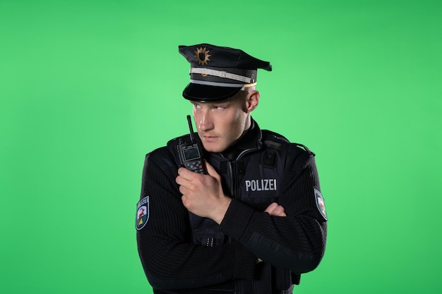 A young handsome man wearing a police uniformgreen background