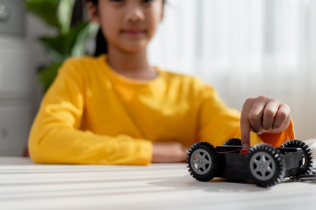 Asia students learn at home in coding robot cars and electronic board cables in STEM STEAM mathematics engineering science technology computer code in robotics for kids concept