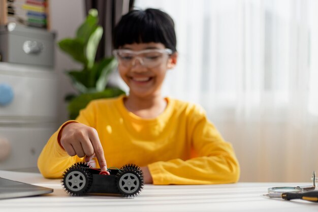 asia students learn at home in coding robot cars and electronic board cables in stem steam mathematics engineering science technology computer code in robotics for kids concept