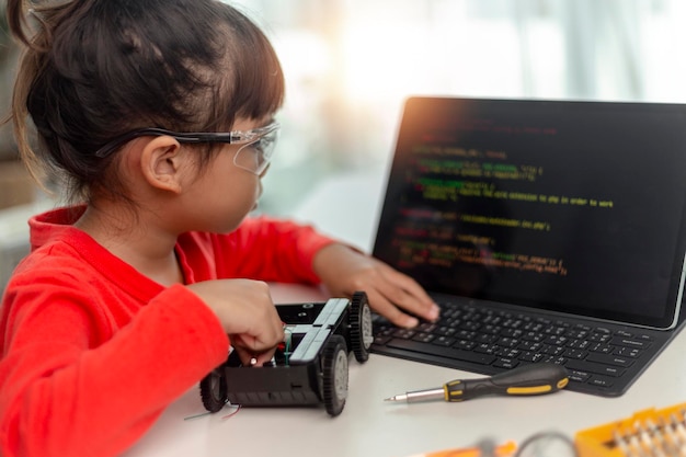 Asia students learn at home in coding robot cars and electronic board cables in STEM STEAM mathematics engineering science technology computer code in robotics for kids concept