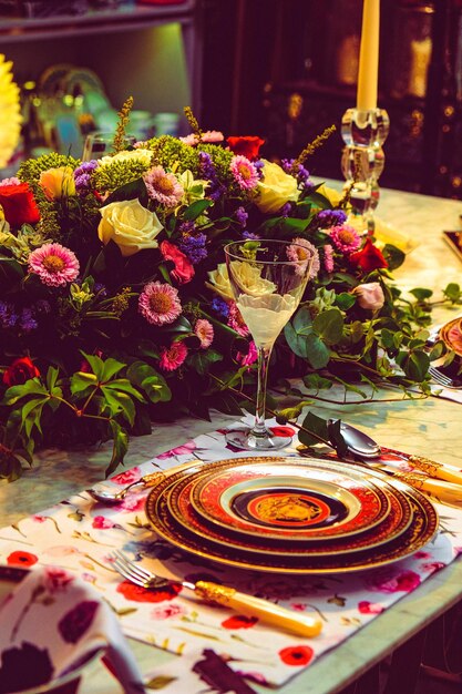 beautiful plate and fresh perfect colorful flowers standing on luxury table