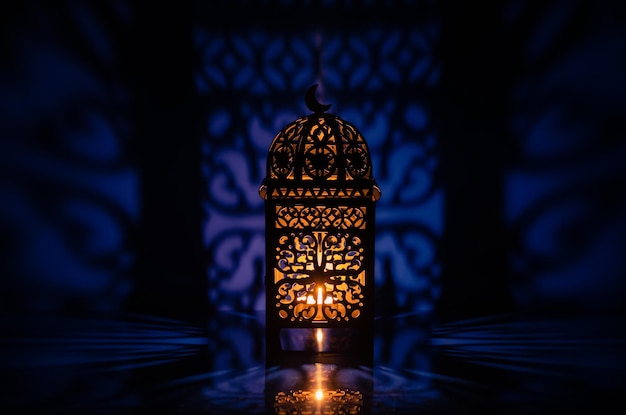 Black lantern with reflection from blue background for ramadan kareem