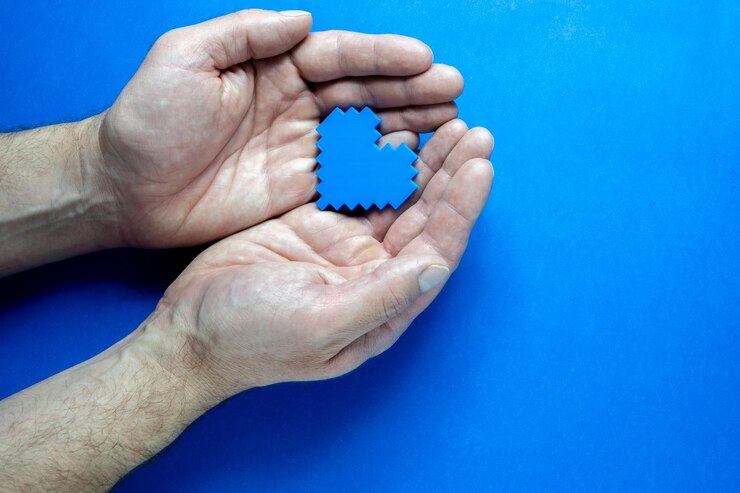 Fotoğraf blue monday concept hands of a man holding a blue heart