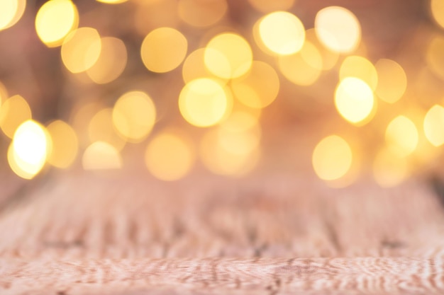Blurred view of the background of Christmas lights in warm light, focus on the floor.