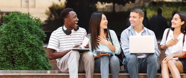 Break Between Classes Happy students sitting on bench at university campus