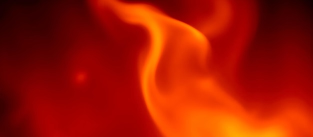 burning flames with glowing firelight on black background bright heat effect red and orange flames intense fire texture warm glow blazing light realistic fire dark backdrop