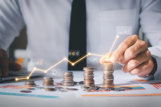Business man putting coins Business growth and investment chart strategic planning to increase profits from doing business longterm investment planning