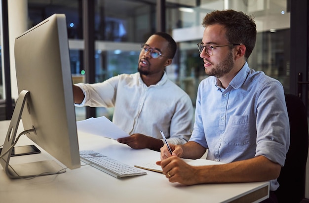 Business meeting marketing at night with computer or teamwork planning collaboration or innovation strategy in startup company Diversity working online or research for partnership deal proposal