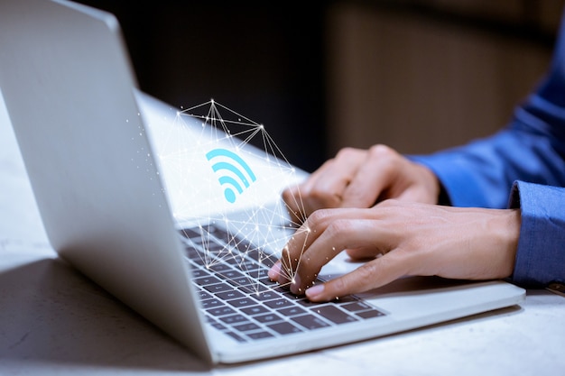 Business using laptop,with wifi icon,business communication social network concept.
