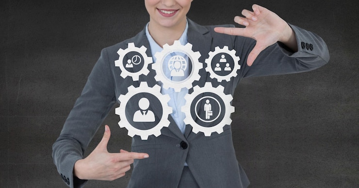 Fotoğraf business woman interacting with people in cogs graphics against grey background