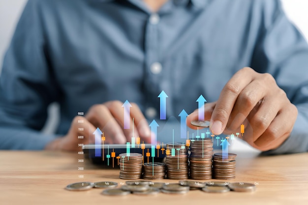 Businessman holding coins stacking with up arrow for financial banking interest rate from money saving and business investment growth from dividend concept