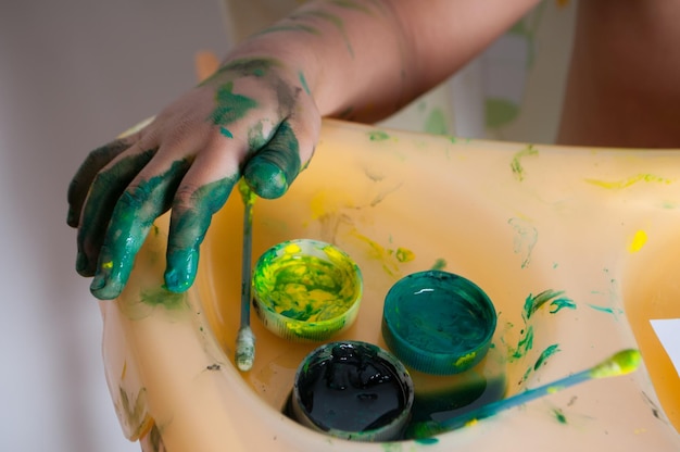 Childs hand with paint