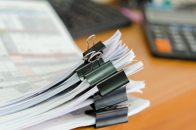 Close-up of papers stacked on table