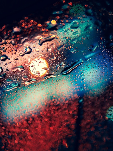 Close-up of raindrops on car windshield