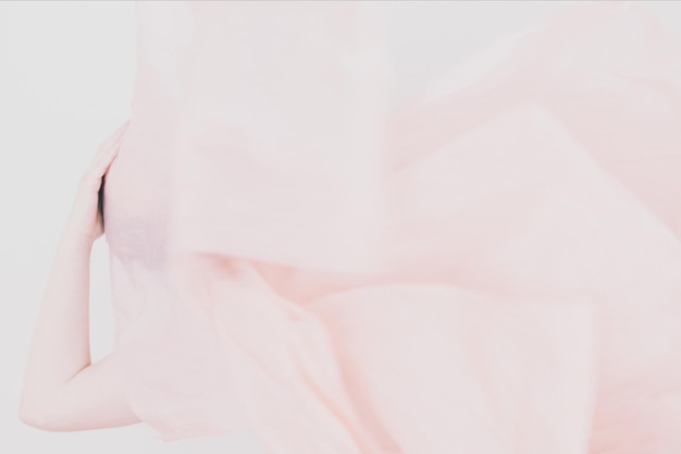 Close-up of woman behind curtain