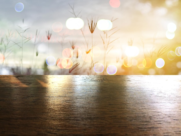 Close-up of wooden table on field during sunset