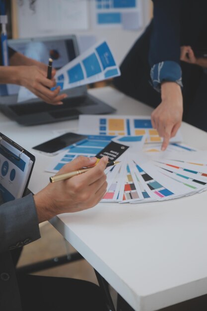 close up ux developer and ui designer use augmented reality brainstorming about mobile app interface wireframe design on desk at modern officecreative digital development agency