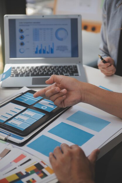 Close up ux developer and ui designer use augmented reality brainstorming about mobile app interface wireframe design on desk at modern officeCreative digital development agency