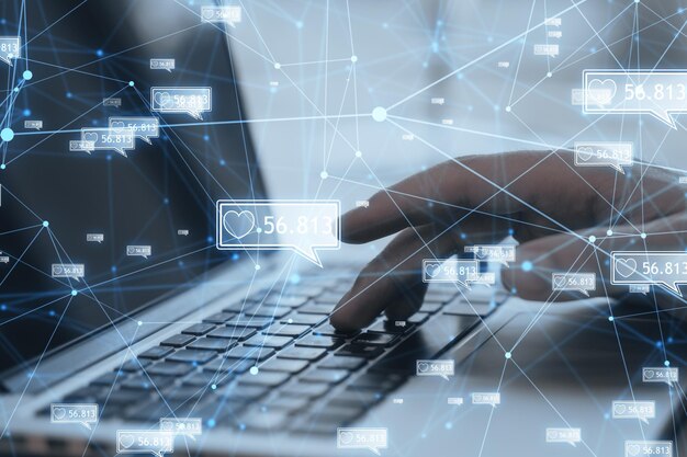 Concept of network and internet communication Close up of male hands using laptop keyboard with creative polygonal likes network on blurry background Double exposure