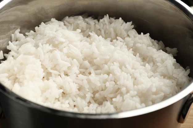 Cooked rice in metal saucepan closeup