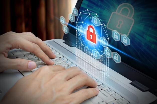 Cropped hands of man using laptop with padlock icon