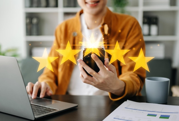 Customer or client the stars to complete five stars with copy space giving a five star rating Service rating satisfaction concept in office