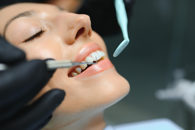 Dentist examining patients teeth close up