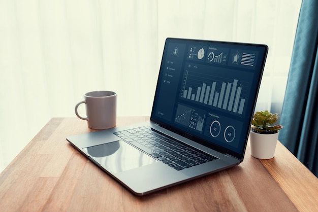 Desk in office with laptop display Fintech dashboard data Enthusiastic