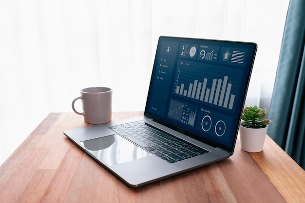 Desk in office with laptop display Fintech dashboard data Enthusiastic