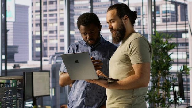 Developer and colleague checking code on notebook doing brainstorming