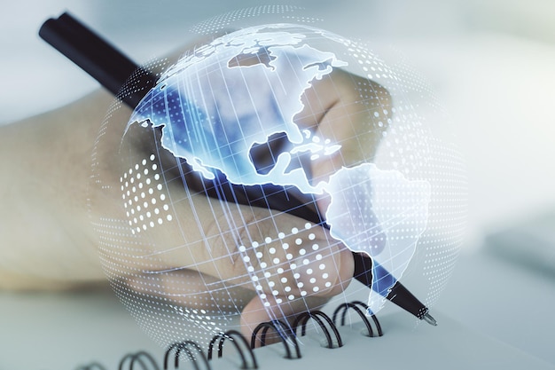 Digital America map and man hand writing in diary on background global technology concept Multiexposure