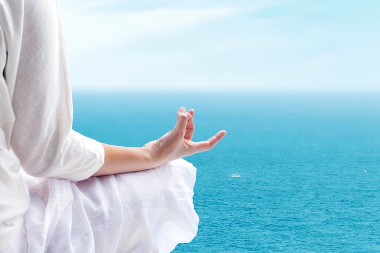 Fotoğraf digital composite image of woman doing yoga over sea