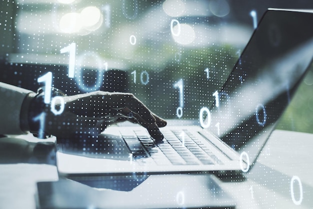 Double exposure of creative abstract binary code hologram and hands typing on laptop on background Database and programming concept